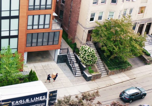 drone-shot-of-moving-truck Movers moving packages out of truck